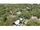 An aerial view showcasing a home among lush trees with neighboring houses adding to the community feel at 12722 Oak Tree Dr, Hudson, FL 34667