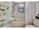 Bright bathroom featuring a tub-shower combo with butterfly accents and natural light from a window at 12722 Oak Tree Dr, Hudson, FL 34667