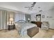 Well-lit bedroom showcasing comfortable seating, carpet floors, and a large dresser at 12722 Oak Tree Dr, Hudson, FL 34667