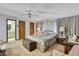Comfortable bedroom featuring a ceiling fan, carpet floors, and ensuite bathroom at 12722 Oak Tree Dr, Hudson, FL 34667