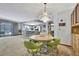 Dining area with unique light fixture adjacent to an open kitchen and serving cabinet at 12722 Oak Tree Dr, Hudson, FL 34667