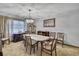 Cozy dining room featuring a classic chandelier and warm ambiance, perfect for intimate gatherings and meals at 12722 Oak Tree Dr, Hudson, FL 34667