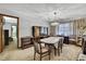 Inviting dining room featuring a classic chandelier and comfortable seating arrangement, ideal for Gathering gatherings at 12722 Oak Tree Dr, Hudson, FL 34667