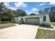 Charming single-story home featuring a two-car garage, well-maintained lawn, and inviting curb appeal on a sunny day at 12722 Oak Tree Dr, Hudson, FL 34667