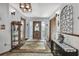 Entryway with a decorative glass display cabinet, accentuating the home's character and style with natural wood tones at 12722 Oak Tree Dr, Hudson, FL 34667