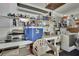 Practical garage laundry area featuring a utility sink, shelves, and washing machine at 12722 Oak Tree Dr, Hudson, FL 34667