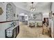 Bright living area with arched entryways, decorative metal art, and neutral carpet, perfect for relaxation and entertaining at 12722 Oak Tree Dr, Hudson, FL 34667