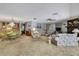 Bright living room featuring carpet floors and a dining room area at 12722 Oak Tree Dr, Hudson, FL 34667