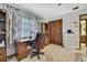 Functional home office with built-in shelving and storage cabinets at 12722 Oak Tree Dr, Hudson, FL 34667