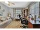 Well-lit office space featuring a comfortable sofa and functional furnishings at 12722 Oak Tree Dr, Hudson, FL 34667