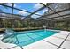 Sparkling pool within a screened enclosure, offering a private backyard oasis at 12722 Oak Tree Dr, Hudson, FL 34667