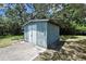 A well-maintained shed offers additional storage space and organization in this backyard setting at 12722 Oak Tree Dr, Hudson, FL 34667
