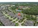 Aerial view of home nestled amongst mature trees near a lake and neighborhood at 12854 Rangeland Blvd, Odessa, FL 33556