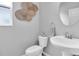 The half bathroom offers a pedestal sink and decorative accents at 12854 Rangeland Blvd, Odessa, FL 33556