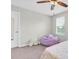 Cozy bedroom featuring a ceiling fan, a bright window, and a beanbag chair, making it a relaxing space at 12854 Rangeland Blvd, Odessa, FL 33556
