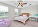 Bright bedroom features a ceiling fan, and a large window, and a desk that is perfect for studying or work at 12854 Rangeland Blvd, Odessa, FL 33556