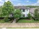 Charming two-story home with manicured lawn, landscaping and a covered front porch at 12854 Rangeland Blvd, Odessa, FL 33556