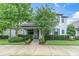 Charming two-story home with well-maintained landscaping, trees, and welcoming front porch at 12854 Rangeland Blvd, Odessa, FL 33556