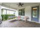 Cozy front porch with swing and rocking chairs, offering a relaxing outdoor space at 12854 Rangeland Blvd, Odessa, FL 33556
