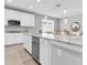 Bright kitchen features white cabinetry, stainless steel appliances, and marble countertops at 12854 Rangeland Blvd, Odessa, FL 33556