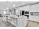 Spacious kitchen with an island, white cabinets, and stainless steel appliances at 12854 Rangeland Blvd, Odessa, FL 33556
