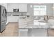 A modern kitchen featuring white cabinets, granite countertops, and stainless steel appliances at 12854 Rangeland Blvd, Odessa, FL 33556