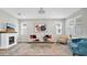 A bright living room featuring a modern fireplace, stylish furniture, and ample natural light at 12854 Rangeland Blvd, Odessa, FL 33556