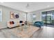 A stylish living room with modern furnishings, elegant decor, and a sliding glass door at 12854 Rangeland Blvd, Odessa, FL 33556