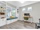 Well-lit home office featuring built-in shelves, a bench, and a modern desk at 12854 Rangeland Blvd, Odessa, FL 33556