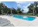Community pool offers a serene escape with comfortable loungers and refreshing water on a sunny day at 12854 Rangeland Blvd, Odessa, FL 33556