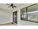 This screened patio with brick pavers offers sliding glass door access and a ceiling fan at 12854 Rangeland Blvd, Odessa, FL 33556