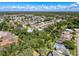 Aerial view of a charming home nestled in a lush, tree-filled neighborhood offering both privacy and natural beauty at 13627 Glaze Brook Dr, Hudson, FL 34667