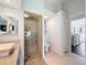 Bathroom with vessel sink, tiled walk-in shower, toilet, and linen closet at 13627 Glaze Brook Dr, Hudson, FL 34667