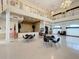 Large, open community room with tables and chairs, featuring a stage and mezzanine area at 13627 Glaze Brook Dr, Hudson, FL 34667