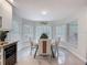 Lovely dining area with a round table, four chairs, plenty of natural light and easy access to the kitchen at 13627 Glaze Brook Dr, Hudson, FL 34667