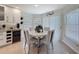 Bright dining area featuring a round table, four chairs, and large windows with blinds, creating a cozy space at 13627 Glaze Brook Dr, Hudson, FL 34667