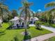Lush landscaping frames this lovely home, complete with healthy palms, verdant foliage, and a paved driveway at 13627 Glaze Brook Dr, Hudson, FL 34667