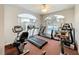 Fully equipped gym featuring treadmills and elliptical machines with a view of the outdoor pool at 13627 Glaze Brook Dr, Hudson, FL 34667