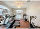 Gym featuring cardio machines, overlooking the community pool through large windows at 13627 Glaze Brook Dr, Hudson, FL 34667