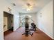 Community gym with weight machines and ceiling fan, offering a secure workout environment at 13627 Glaze Brook Dr, Hudson, FL 34667
