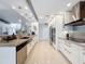 Modern kitchen features granite countertops, stainless steel appliances, tile flooring, and ample cabinet space at 13627 Glaze Brook Dr, Hudson, FL 34667