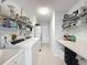 A well-organized laundry room with modern appliances, countertops, sink and ample shelving at 13627 Glaze Brook Dr, Hudson, FL 34667