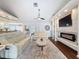 Cozy living room with a modern fireplace, recessed lighting, and sliding glass doors to the outdoors at 13627 Glaze Brook Dr, Hudson, FL 34667