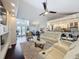 Spacious living room with an open floor plan, seamlessly connecting to the kitchen and dining areas at 13627 Glaze Brook Dr, Hudson, FL 34667