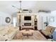 Living room featuring a fireplace, built-in shelving, and a modern ceiling fan for comfort and style at 13627 Glaze Brook Dr, Hudson, FL 34667