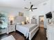 Spacious main bedroom featuring a ceiling fan, ensuite, wood floors, and neutral colors at 13627 Glaze Brook Dr, Hudson, FL 34667