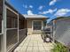 Outdoor patio with grill, privacy features, and access to both the backyard and sunroom at 13627 Glaze Brook Dr, Hudson, FL 34667
