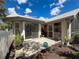 Back patio area with pavers, potted plants, and sliding door access to the home at 13627 Glaze Brook Dr, Hudson, FL 34667