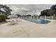 A community pool features lounge seating and fencing for secure enjoyment in the neighborhood at 13627 Glaze Brook Dr, Hudson, FL 34667