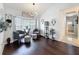 Inviting sitting area with hardwood floors, bay window, and comfortable armchairs, naturally lit at 13627 Glaze Brook Dr, Hudson, FL 34667